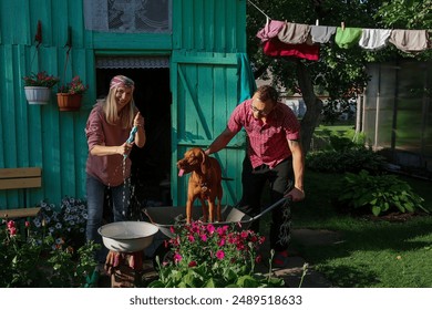 Couple with dog doing laundry in the countryside in the summer - Powered by Shutterstock