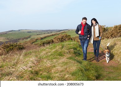 Couple With Dog Walking Along Coastal Path - Powered by Shutterstock