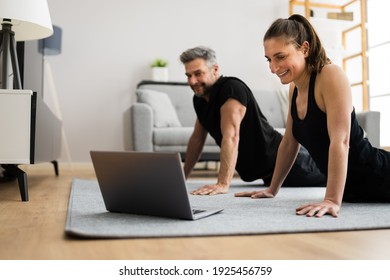 Couple Doing Online Stretching Class Workout And Fitness Exercise