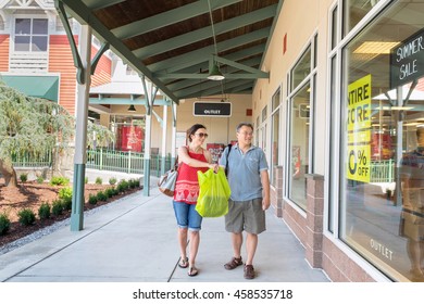 A Couple Doing Outdoor Outlet Mall Shopping