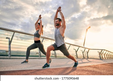 Couple Doing Sport Together On The Street. Yoga In The Morning