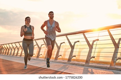 Couple doing sport together on the street. Morning run - Shutterstock ID 1775826200