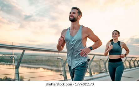 Couple doing sport together on the street. Morning run