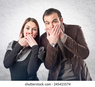 Couple Doing Surprise Gesture Over Textured Background 