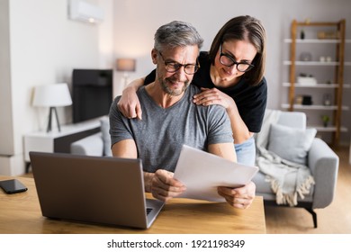 Couple Doing Taxes And Family Budget On Computer