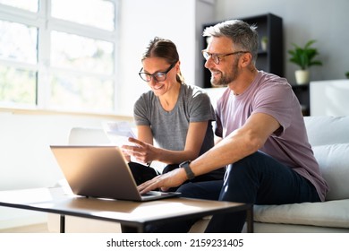 Couple Doing Taxes And Family Budget On Computer