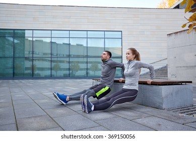 couple doing triceps dip exercise outdoors