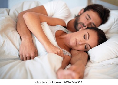 Couple, dreaming and rest in bedroom of home, peace and man together with woman in bed. Marriage, love and partners hugging for romance with care, relax and pyjamas for sleeping in house and embrace - Powered by Shutterstock