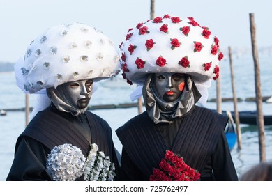 Couple Dressing Carnival Black Costumes Representing Game Cards At The Carnival Of Venice, Italy.