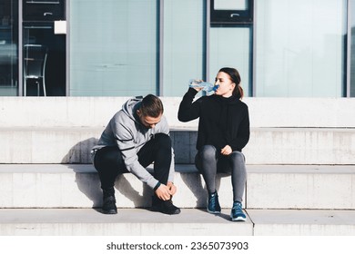 Couple drink water during workout in ubran city area. Active lifestyle