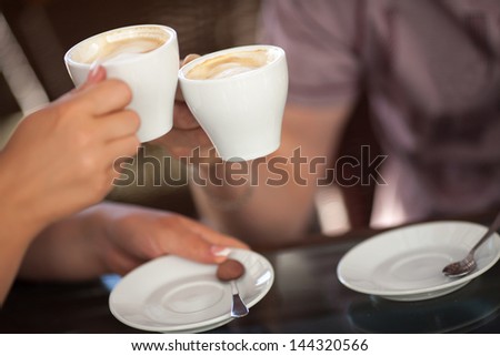 Couple drinking coffee at cafe restaurant man and woman with cup of espresso hot cappuccino on dating. Concept of male and female hands love and coffee. Italian delicious caffeine drink aroma latte
