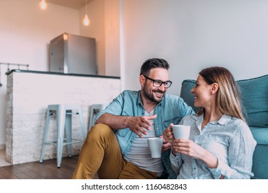 Couple Drinking Coffee At Home.