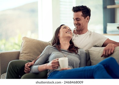 Couple, drinking coffee and laugh in home living room, talking or bonding together to relax. Tea cup, happy man and woman in funny conversation on sofa for healthy relationship, connection or support - Powered by Shutterstock