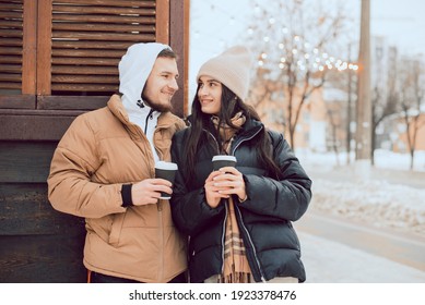 A Couple Are Drinking Coffee Outside A Street Coffee Shop.