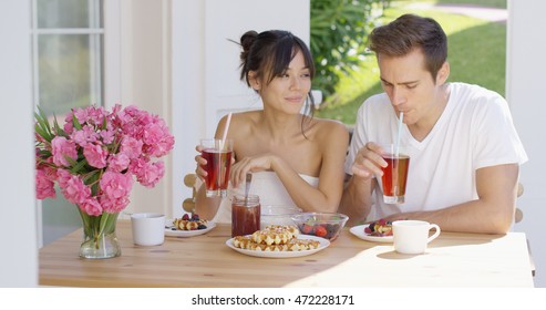 Couple Drinking Iced Tea At Breakfast Outside