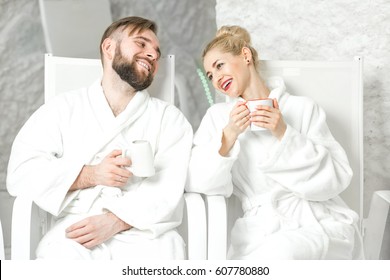 Couple drinking mineral water sitting in the salt room. Applying salt therapy in the Spa