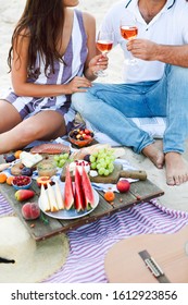 Couple Drinking Rose Wine At Picnic On The Beach Together