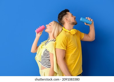 Couple drinking soda on color background - Powered by Shutterstock