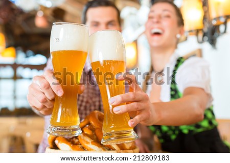 Couple drinking wheat beer in bavarian restaurant