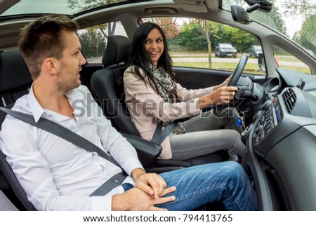 couple is driving in a car