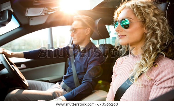 Couple driving car during\
test drive