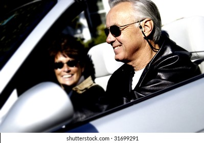 Couple driving in convertible