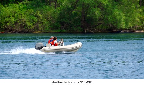 A couple driving an inflatable boat on a river