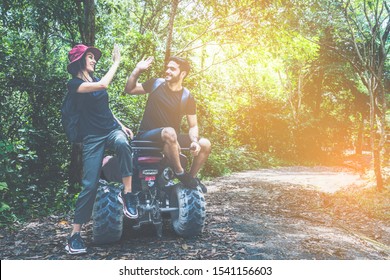 Couple Driving Off Road Adventure With ATV,UTV Bike Quad Bike On The Mountain. Couple Love High Five Hand.