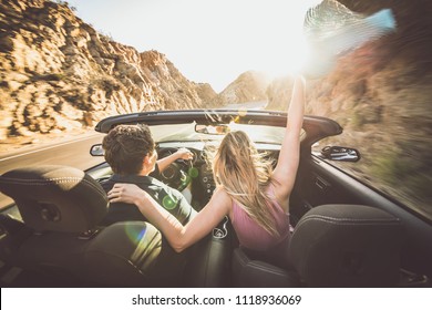 Couple Driving On A Convertible Car