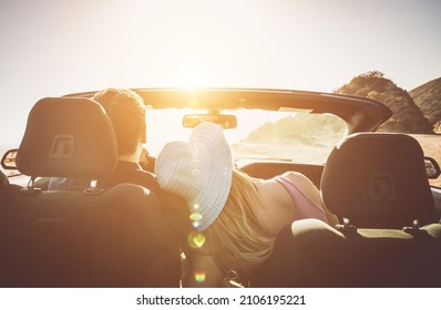 Couple driving on a convertible car - Powered by Shutterstock