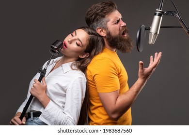 Couple Duet With Microphone Singing Song. Musician In Music Hall.