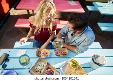 Couple Eating Authentic Street Tacos At Outdoor Mexican Restaurant