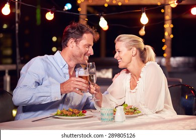 Couple eating dinner at rooftop restuarant