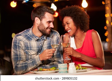 Couple eating dinner at rooftop restuarant