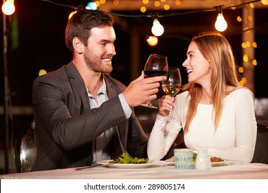 Couple Eating Dinner At Rooftop Restuarant