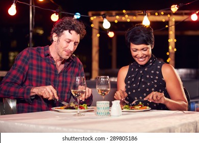 Couple Eating Dinner At Rooftop Restuarant