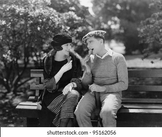 Couple Eating Ice Cream Cones In Park