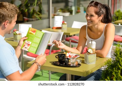 Couple eating looking at menu cafe restaurant smiling woman - Powered by Shutterstock