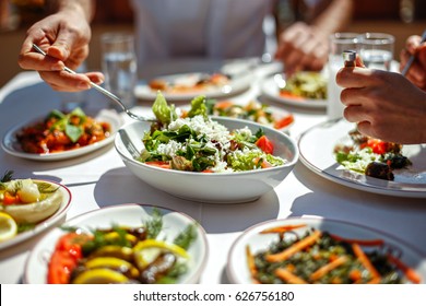 Couple  Eating Lunch with Fresh Salad and Appetizers - Powered by Shutterstock