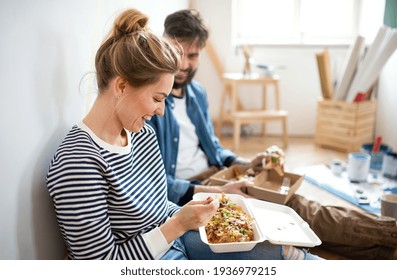 Couple Eating Lunch Indoors At Home, Relocation, Diy And Food Delivery Concept.