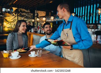 couple eating lunch in restaurant. waiter serving - Powered by Shutterstock