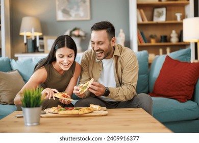 Couple eating pizza at home. They are enjoying in weekend. Valentine's day at home. - Powered by Shutterstock