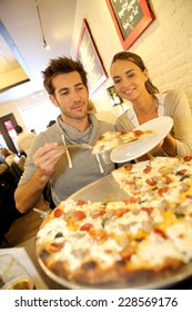 Couple Eating Pizza In New York City