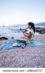 Couple Eating Pizza On The Beach Of Cala Gonone Sardinia Italy August 2019