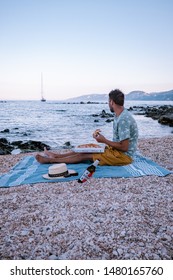 Couple Eating Pizza On The Beach Of Cala Gonone Sardinia Italy August 2019