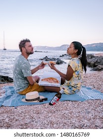 Couple Eating Pizza On The Beach Of Cala Gonone Sardinia Italy August 2019