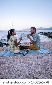 Couple Eating Pizza On The Beach Of Cala Gonone Sardinia Italy August 2019