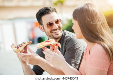 Couple Eating Pizza Snack Outdoors,having Fun.