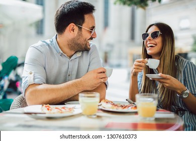 Couple eating pizza snack outdoors.They are sharing pizza and eating. - Powered by Shutterstock