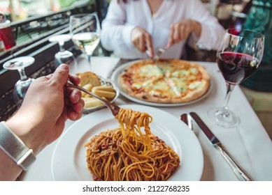 couple eating in restaurant pasta and pizza drinking wine first person point of view no face - Powered by Shutterstock